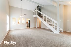 Houston house for rent - A spacious living room with a staircase leading to the upper floor.