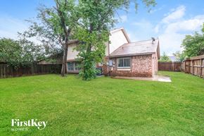 Houston house for rent - A house with a lawn and trees in the background.