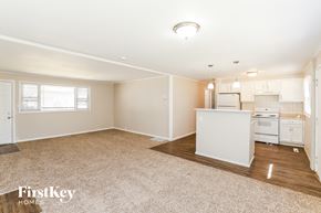 Gladstone house for rent - a kitchen with white cabinets and a white counter top