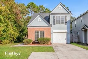 Jacksonville house for rent - a brick house with a white garage door and a blue house