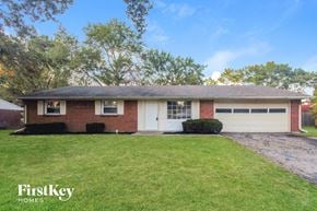 Indianapolis house for rent - A house with a white garage door is for sale.