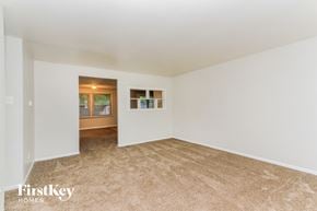 Indianapolis house for rent - A room with a carpeted floor and a window.