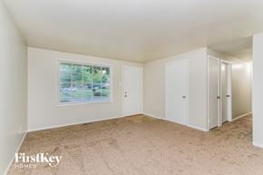 Indianapolis house for rent - A room with a carpeted floor and a window showing an outdoor view.