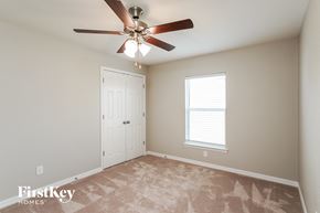 Cape Coral house for rent - a bedroom with a ceiling fan and a closet