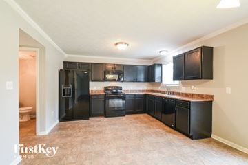 Fishers house for rent - A kitchen with black appliances and cabinets.