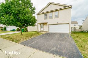 Blacklick house for rent - A two-car garage is attached to a house.