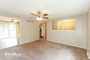 Liberty house for rent - A spacious room with a ceiling fan and a large window.