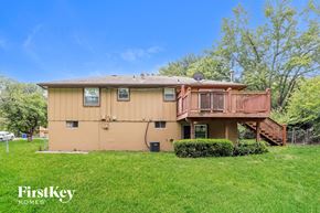 Liberty house for rent - A house with a brown exterior and a balcony is for sale.
