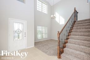 Melissa house for rent - the entryway of a home with a staircase and a white door