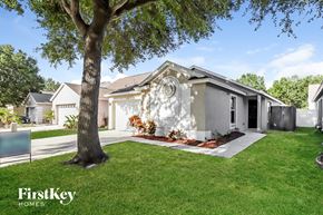 Riverview house for rent - a white house with a tree in front of it