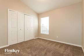 Riverview house for rent - a bedroom with carpet and two closets and a window