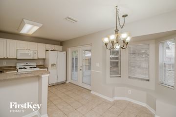 Riverview house for rent - a kitchen with white cabinets and a counter top