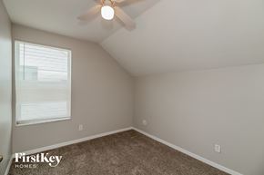 Riverview house for rent - the bedroom has a ceiling fan and a carpet