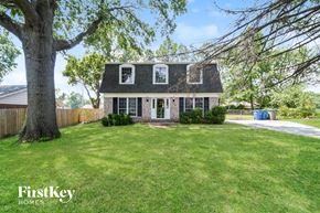Saint Louis house for rent - a house with a yard and a large tree
