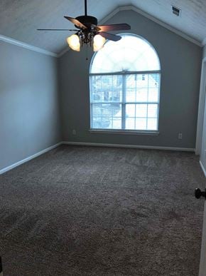 Mcdonough house for rent - A room with a ceiling fan and a window with a view of a building outside.