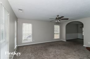 Austell house for rent - A spacious room with a ceiling fan and two windows.