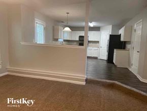 Hampton house for rent - an empty living room and kitchen with a hard wood floor