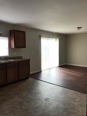 Indianapolis house for rent - A kitchen with brown cabinets and a tile floor.