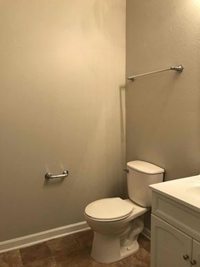 Indianapolis house for rent - A white toilet sits next to a white sink in a bathroom.