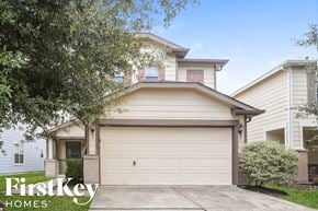 Tomball house for rent - A house with a garage door and a tree in front of it.