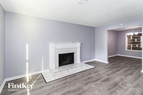 Alpharetta house for rent - a living room with a fireplace and a wooden floor
