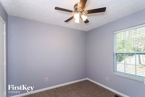 Alpharetta house for rent - a bedroom with a ceiling fan and a window