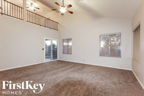 Glendale house for rent - the spacious living room with carpeting and a ceiling fan