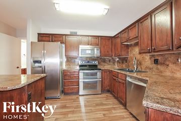 Glendale house for rent - a kitchen with wooden cabinets and stainless steel appliances