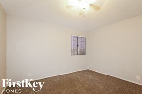 Glendale house for rent - a bedroom with white walls and carpet and a window