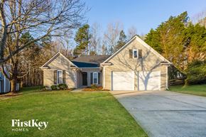 Charlotte house for rent - a house with a driveway and a garage door