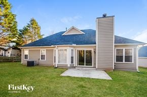 Charlotte house for rent - the front of a house with a yard and a concrete walkway