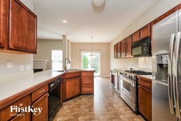 Fishers house for rent - A kitchen with wooden cabinets and stainless steel appliances.
