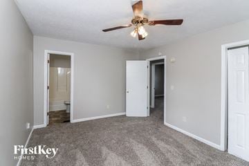 Stone Mountain house for rent - a living room with carpet and a ceiling fan