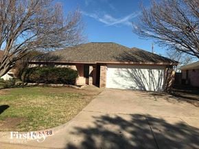 Crowley house for rent - a house with a driveway and a garage door