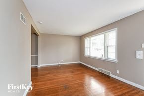 Saint Louis house for rent - a living room with wood floors and a large window