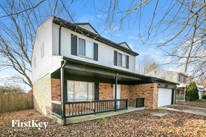 Indianapolis house for rent - A house with a brick wall and a porch.