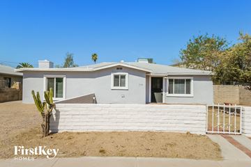 Tempe house for rent - a white house with a white fence and a cactus