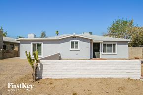 Tempe house for rent - a white house with a white fence and a cactus