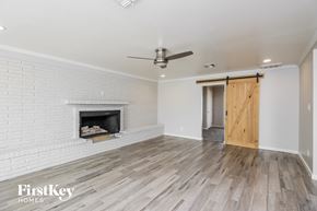 Tempe house for rent - a living room with a white brick fireplace and a wooden door