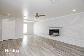 Tempe house for rent - a living room with a white brick fireplace and wooden floors