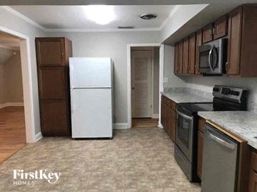 Jacksonville house for rent - a kitchen with a white refrigerator and a stove