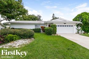 Largo house for rent - a white house with a driveway and a lawn