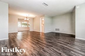 Largo house for rent - an empty living room with wood flooring and white walls