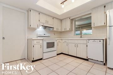 Largo house for rent - a white kitchen with white appliances and white cabinets
