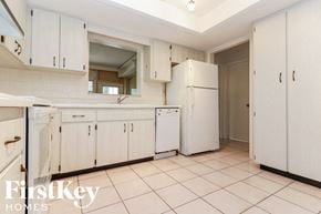 Largo house for rent - a white kitchen with white cabinets and white appliances
