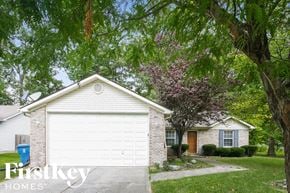 Indianapolis house for rent - a white garage door in front of a white house