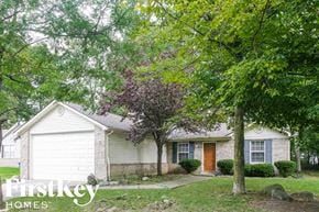Indianapolis house for rent - a small white house with trees in front of it