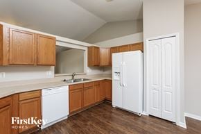 Clermont house for rent - a kitchen with white appliances and wooden cabinets