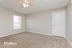 Clermont house for rent - a bedroom with a white door and a ceiling fan