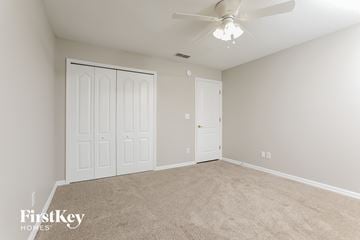 Clermont house for rent - the living room of a new home with carpet and a ceiling fan